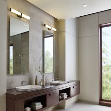 In this art deco pad in chicago, the master bath's custom vanities are in belgian black marble supported by bronze legs; Lynk Bath Vanity Light Bathroom Interior Modern Bathroom Bathroom Interior Design