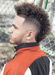 She's styled her curls perfectly, making them more like waves that swoop and feather over her forehead, where her bangs draw attention to her eyes. Mohawk Fade Haircut A New Take On The Hawk