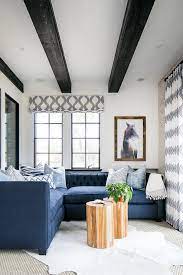 Wood beams are an amazing addition to your home! Blue Tufted Sectional With Black Wood Ceiling Beams Transitional Living Room