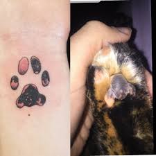 Here, a power button symbol is tattooed on the wrist. Got My Baby S Paw Tattooed On My Wrist By Redbeard Good Land Tattoo Milwaukee Wi Tattoos
