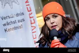 Hamburg, Germany. 25th Nov, 2025. Anna Gallina (Alliance 90/The Greens),  Senator for Justice and Consumer Protection, speaks next to an orange bench  in front of the district office in Mitte during a