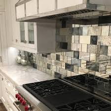 A mirrored backsplash can add a lot of reflective light and additional space into your kitchen. Strip Tile Antique Mirror Subway Tiles