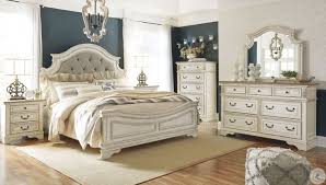 We carry a large selection of bedroom furniture on sale. Realyn Chipped Two Tone Upholstered Panel Bedroom Set From Ashley Coleman Furniture
