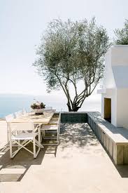 With A Stunning Beach View White Dining Chairs Surround A White Patio Dining Table Outdoor Dining Set Outdoor Outdoor Decor