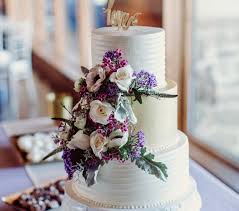 For a change, incorporate your wedding colours in the form fresh flowers (like this bride did with lavender) on top of a simple wedding cake. Weddings All In The Mix Bakeshop