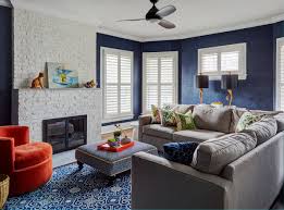 The drapes, sofa, rug, and wall accent in soft navy give a very stylish color touch to the room with the white walls and wood flooring. 35 Blue Living Rooms Made For Relaxing