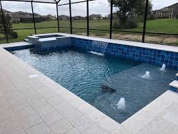 Swimming Pool And Spa With Tanning Ledge And Water Features Florida Pool Swimming Pool Builder Spa Pool