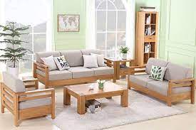 Simple living room with one small white sofa, one white armchair and one armless antique chair around a rectangular dark brown coffee table. 10 Samples Of Beautiful And Simple Living Room Furniture