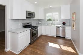 Beautiful Warm Wood Floors White Cabinets Stainless Steel Appliances Gray Counters Gray Paint Make A Warm Contemporary Kitchen Warm Wood Flooring Warm Wood