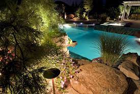 The Classic Shape Of This Pool Is Exquisitely Complimented By The Artistic Placement Of Natural Ston Clearwater Tampa Outdoor Lighting Systems Outdoor Lighting