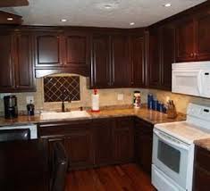 Rich Mahogany Cabinets Pricing Etc Maybe This Color For The Cabinets With Black Appli Mahogany Kitchen Maple Kitchen Cabinets Kitchen Cabinets Materials