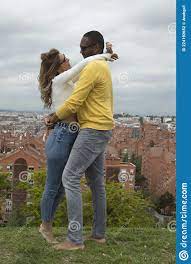 Young Interracial Couple Hugging, Laughing and Kissing in a Park Stock  Photo - Image of looks, outdoors: 224192652