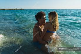 Go all the way (100%) with the best in industry polarization! Couple In Sunglasses Posing In Ocean Waves Looking At Each Other Freedom Stock Photo 176690406
