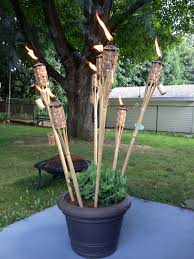 Potted Tiki Torches The Mosquitos Don T Stand A Chance Nautical Outdoor Decor Tiki Torch Stand Backyard Bar