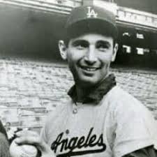 Newly signed 18-year-old rookie pitcher Sanford "Sandy" Koufax poses in  front of the Brooklyn #Dodgers chalkboard roster & Merry Christmas banner!  (December 1954) #MLB #Xmas #Baseball #History