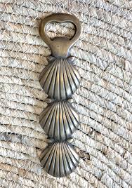 Quite possibly the greatest way to open your next bottle of whatever. Shell Brass Bottle Opener White Bohemian