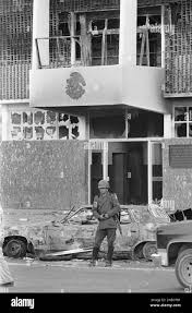 A Mexican soldier stands guard in front of a charred auto in front of the  Piedras Negras City Hall and jail, Dec. 31, 1984, after supporters of a  defeated mayoral candidate set