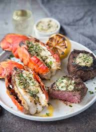 We've compiled our 6 favorite lobster and steak recipes with instructions and after your lobster is done baking, serve each steak half with 2 halves of lobster tails and garnish with rosemary if you wish. Surf And Turf On The Grill With Herb Compound Butter Vindulge