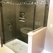 Navy blue hues repeat on this shower's floor tile and shelving backsplash. What Is The Most Expensive Part Of A Bathroom Remodel