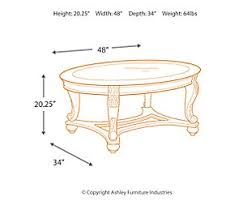 This oval cocktail table is graced with a wood framed top with cast filigree. Norcastle Coffee Table Ashley Furniture Homestore