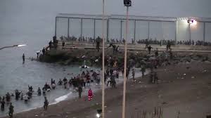 Spain deployed its military to beaches surrounding the city, as more than 6,000 thousand new arrivals, many of them teenagers, emerged from the sea to a wall of soldiers. Djy7ofwfgskpsm