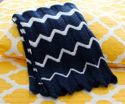 Black And White Striped Crochet Blanket Crocheted Blanket With Navy And White Zig Zag Stripes Folded Laying On A Yellow Backgro Crochet Blanket Chevron Baby Boy Crochet Blanket Baby Blanket Crochet