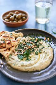 Herb Hummus Starter With Pita Bread And Olives Stocksy United Hummus And Pita Pita Bread Hummus