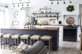 Black and white wooden backless round stools at a blue gray shiplap kitchen island finished with a white quartz countertop in a cottage kitchen design. Our Modern Farmhouse Kitchen Makeover The Reveal