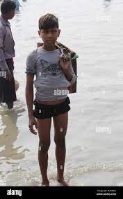 Teenage Indian Boy Searching Devote Coins at Sea Water During The Holy Bath  Festival Stock Photo - Alamy