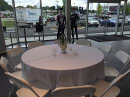 White Hercules Chairs And 60 Round Tables At The Jim Ellis Audi Atlanta Showroom Party Event Re Party Chair Rentals Pool Lounge Chairs Table Linen Rentals