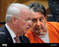 Bobby Thompson, right, talks with his attorney Mark Stanton during his  hearing in Cuyahoga County Court in Cleveland