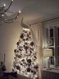 Ribbon, garland, floral picks, clip on birds, and feather sprays. Tree Topper Christmas Tree Inspiration Elegant Christmas Trees Peacock Christmas Tree
