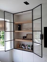 Contemporary kitchen features black metal cabinets fitted with chicken wire and glass cabinet doors. Black Steel Glass Cabinet Doors Jessica Devlin Design
