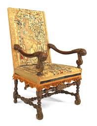 Offered is a beautiful antique carved walnut stool with antique tapestry textile upholstery. English Renaissance Walnut Tapestry Chairs