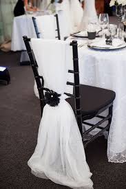 Easy Chair Back Decor Tulle Secured With Flower Timelesstreasure Chairs Black And White Wedding Theme White Wedding Decorations White Wedding Theme