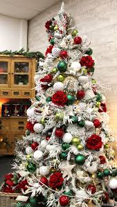 A Frosty Tree With Vibrant Red And Green Accents Christmas Tree Themes Flocked Christmas Trees Decorated Corner Christmas Tree