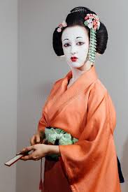 The traditional white base makeup was, the red lipstick and red and black accents around the eyes and eyebrows are typical geisha makeup. Woman In Geisha Makeup And A Traditional Japanese Kimono Studio Indoor Stock Image Image Of Look Fashion 114002731