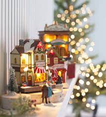Taking photographs in front of the christmas tree with hyper boys doesn't seem to allow for a natural light set up. 17 Piece Lighted Christmas Village Wind And Weather