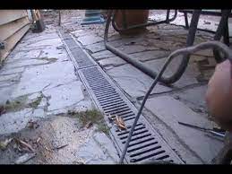 If the low area is only 2 inches deep, a better solution might be to fill it in. Adding Sump Pump To Channel Drain For Better Dranage Youtube