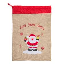 Santa claus holding sack and pointing up while looking at camera isolated on white. Santa Present Sack