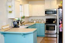 We used a small foam roller for the flat surfaces and a brush to get in the ridges created by the beadboard and raised. Painting Kitchen Cabinets With Chalk Paint White Blue Kitchen Cabinets Painting Kitchen Cabinets Annie Sloan Kitchen Cabinets Kitchen Cabinets