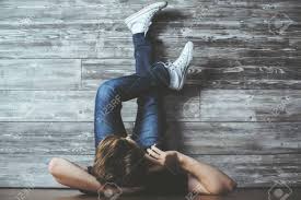 Young Guy Talking On Phone While Lying On Floor With Feet Up Wooden Plank  Wall. Communication Concept Stock Photo, Picture and Royalty Free Image.  Image 65094887.