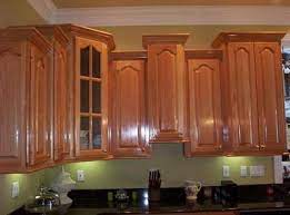 The key is that the taller cabinets must be deeper than the lower cabinets if you want the crown to die cleanly into the side. Crown Molding With Staggered Cabinets