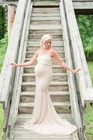 Beaming pregnant women wearing stylish baggy pink dress showing photos of her wedding. Baby Toddlers Kids Parenting This Pregnant Bride Had The Best Accessory For Her Glowing Wedding Popsugar Family Photo 10