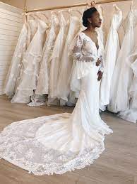 Boho Wedding Dress With Low Neckline Bell Sleeves And A Long Train This Form Fitting Dress Has Layer Wedding Dresses Boho Wedding Dress Wedding Dresses Lace