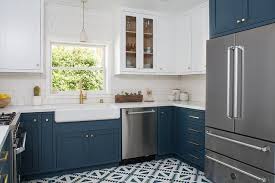White And Blue Transitional Kitchen Featuring White Upper Cabinets With Dark Blue Lower Cabinets Finished Blue Kitchen Cabinets Chic Kitchen Hague Blue Kitchen