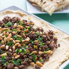 The meat mixture is shaped into balls, patties or logs, and then grilled and served with pita, salads, dips, and sauces. Hummus With Ground Lamb And Toasted Pine Nuts The Lemon Bowl