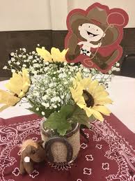 A wooden horse can be put up in the party venue. Cowboy Western Theme Baby Shower Center Pieces Baby Breaths Sunflowers From Wal Mart Pic Cowboy Baby Shower Theme Cowboy Baby Shower Boy Baby Shower Themes