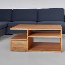 This coffee table leans into its coastal farmhouse look with natural wood finishes and a mixed material design. Design Couchtische Aus Holz Modum