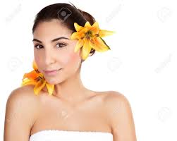 Photo Of Beautiful Arabic Woman With Yellow Lily Flower In Head, Portrait  Of Cute Brunette Girl Wearing Bath Towel Isolated On White Background,  Natural Facial Cosmetics, Beauty And Spa Concept Stock Photo,